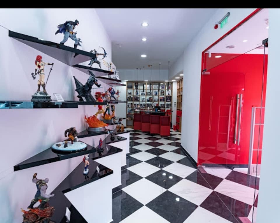 Entrance hallway with shelves of collectible figures and a checkerboard floor