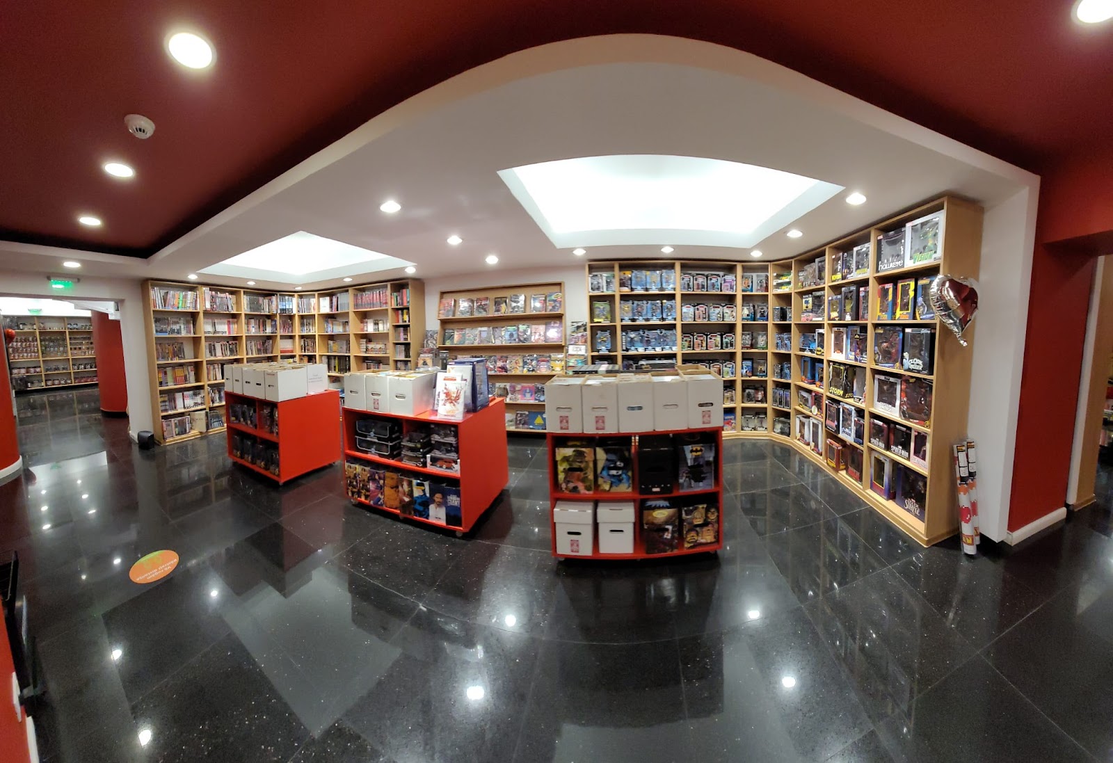 Wide view of the upper gallery packed with comics, Funko Pops and figures